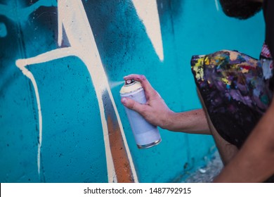 Street Artist Painting Colorful Graffiti On Generic Wall - Modern Art Concept With Urban Guy Performing And Preparing Live Murales With Multi Color Aerosol Spray