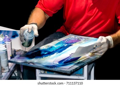 Street Artist spray painting souvenir surfboards. Painter's hands covered in latex gloves. - Powered by Shutterstock