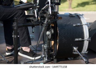 Street Band Playing Music. Close Up View Of Drummer Legs, Kick Drum. Low Light Background