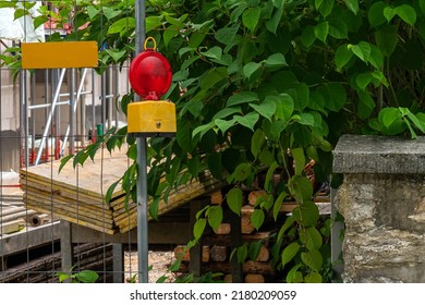 Street Barricade With Warning Signal Lamp On A Fence. Construction Safety.