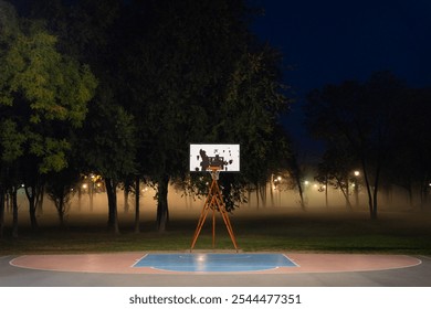 Street basketball court early in the foggy and misty morning. Emptiness and sadness. Abandoned outdoor basket ball field. Scary autumn scene with dense fog in background. - Powered by Shutterstock