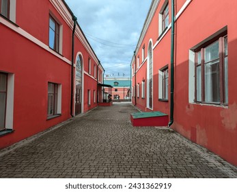 A street with beautiful red buildings and with paving stones