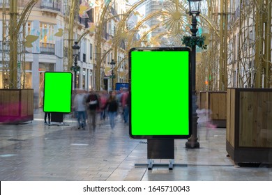 Street Billboard sign with green screen , Mock up of an Outdoor Billboard Advertisement against busy pedestrian street blurred on purpose in historical center of,european city - Powered by Shutterstock