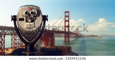Street binoculars in front of unfocused Golden Gate Bridge panorama. San Francisco. California. USA.