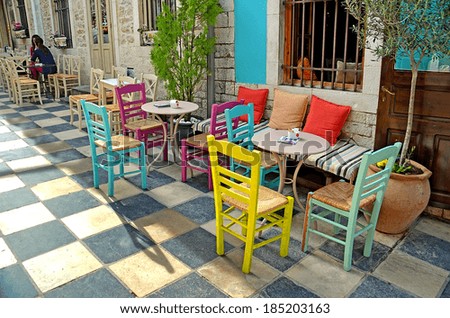 street cafe tables chairs  - ioannina athens city greece - road like chess - yellow blue pink colors