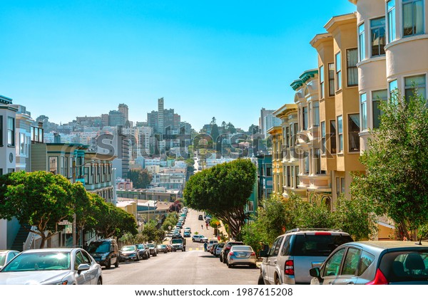 A street in the center of the city with a sloping\
road and a beautiful view of the downtown. San Francisco, USA - 17\
Apr 2021