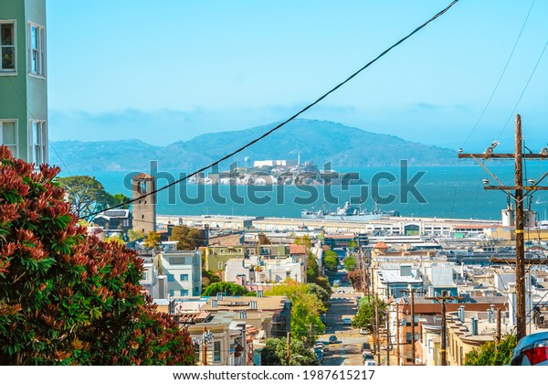 A street in the center of the city with a sloping\
road and a beautiful view of the downtown. San Francisco, USA - 17\
Apr 2021