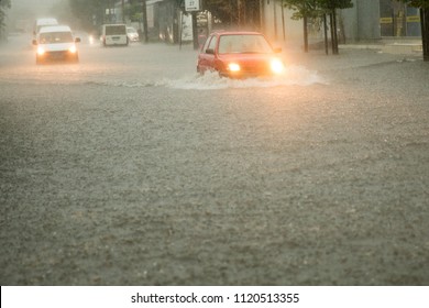 Street Of The City Flooded After Heavy Rains. Cars Driving On The Flood