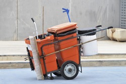 Street Cleaner Tools In An Orange Cart. Street Cleaning Service