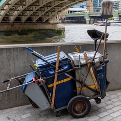 A Street Cleaning Cart On Bankside Under Southwark Bridge By The River Thames In South London, United Kingdom