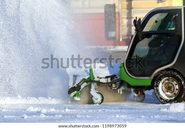 street cleaning the city from snow with the
help of special
machinery