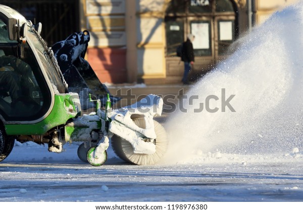 street cleaning the city from snow with the\
help of special\
machinery