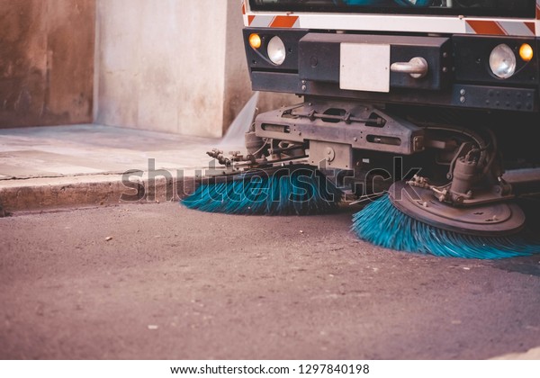 Street\
cleaning machine washes the street. Road\
machinery