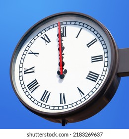 Street Clock Showing Exactly Noon. 12:00 Isolated On Blue Sky Background