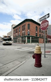 Street Corner In Detroit Michigan USA. A City Bus In Rounding The Corner.