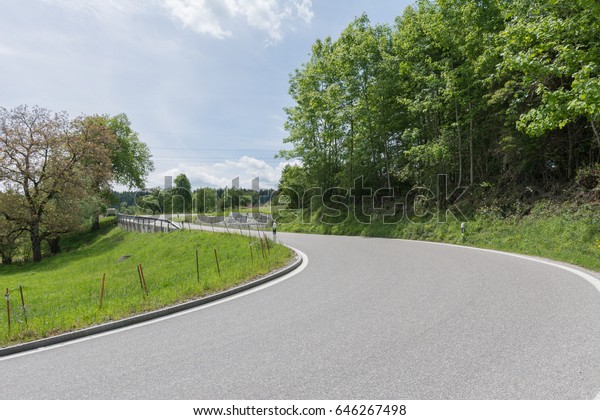 Street with curve and\
forest