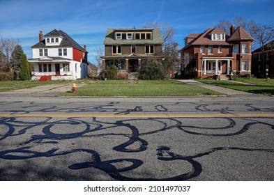 A Street In Detroit, Michigan With An Abandoned House On The Block