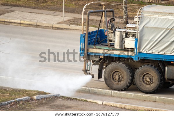 Street disinfection, the machine sprays\
medicines on the road and\
sidewalk.