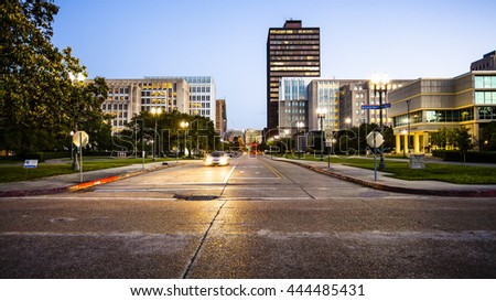 Street in downtown Baton Rouge, Louisiana as night falls - skyline