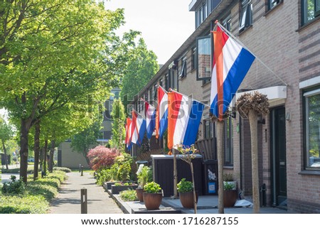 Street with dutch flags hanging outside on 