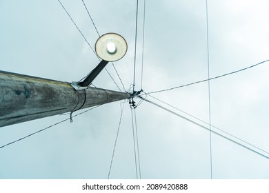 Street Electric Pole With Many Electrical Wires And Fiber Optic Cables