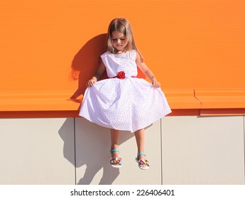 Street Fashion Kid, Little Girl In Dress Near Colorful Wall Outdoors