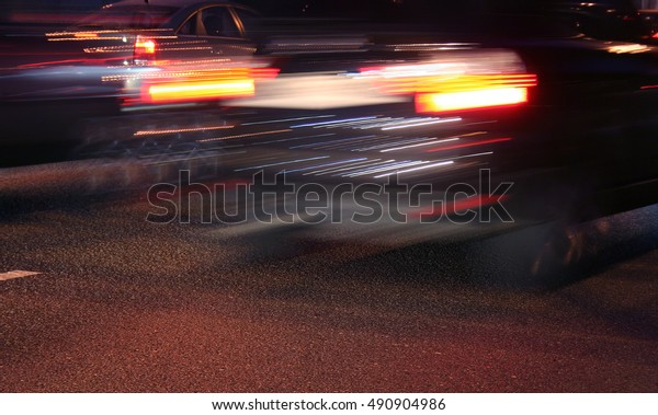 Street with\
fast moving cars by a  night in \
Moscow