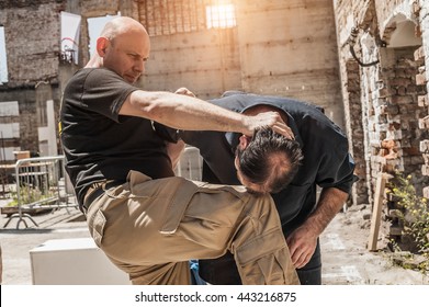 In a street fight one man strikes the other with knee to the head - Powered by Shutterstock