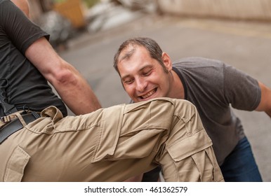 In a street fight one man strikes the other with knee to the head - Powered by Shutterstock