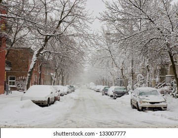 The street filled with fresh snow during a snow storm