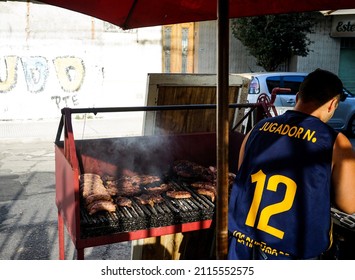 Street food of Buenos Aires, Argentina, January 2020. Argentinian Red steaks on grill, local seller is selling on streets to tourist at La Boca, Buenos Aires.