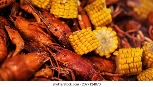 Street food. Casserole with red boiled crawfish and corn