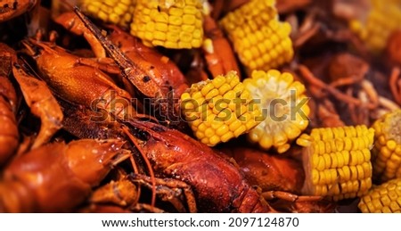 Street food. Casserole with red boiled crawfish and corn