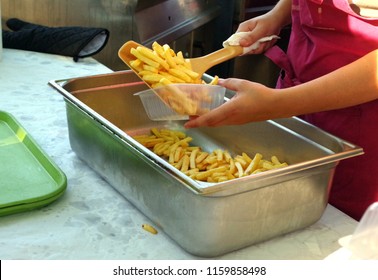 Street Food, An Employee Prepares Servings Of French Fries For The Sale.