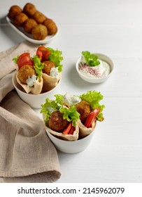 Street Food. Falafel In A Pit With Vegetable Salad. Oriental Fast Food. Close-up, On A Light Background