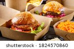 Street food. Meat cutlet burgers are in paper boxes. Food delivery.