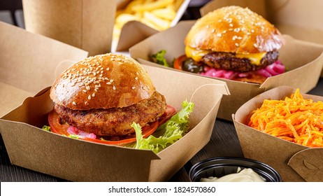 Street food. Meat cutlet burgers are in paper boxes. Food delivery. - Powered by Shutterstock