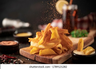 Street food plate with mozzarella sticks, chicken wings, onion rings, french fries and dip - Powered by Shutterstock