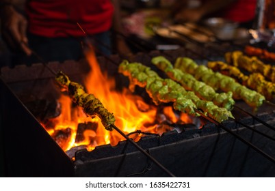 Street food/Traditional Grilled tandoori of  assorted meats with charcoal and fire on skewers