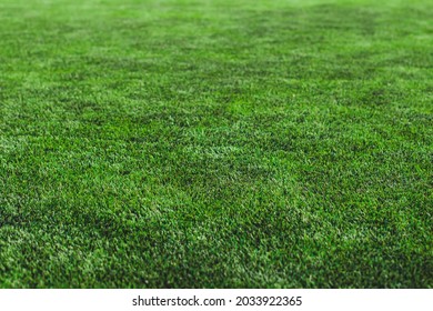 Street Football Outdoor Game On An Artificial Astroturf Lawn, Soccer Game On A Pitch Field With A Team In A Background