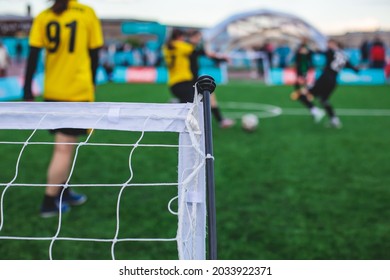 Street Football Outdoor Game On An Artificial Astroturf Lawn, Soccer Game On A Pitch Field With A Team In A Background