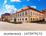 Street with Herzer palace with flags in Old city of Varazdin in Croatia. Panorama and Cityscape of famous Croatian town in Europe in summer. Travel and tourism for tourists.