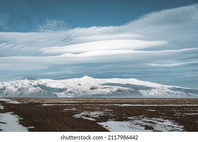 Street Highway Ring road No.1 in Iceland, with view towards massive glacier with beautiful lenticular clouds. Southern side if the country. Road trip travel concept.