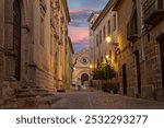 Street of the historic center of Baeza with blurred people walking in Baeza, Jaén, Andalusia, Spain at dusk, UNESCO heritage