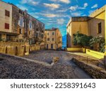 Street with historic houses in Calvi old town, Corsica island, France