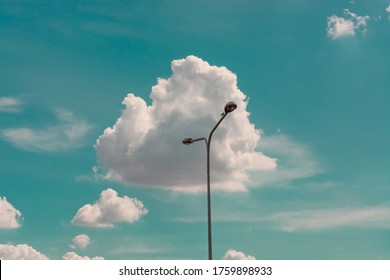 street lamp against the blue sky and clouds