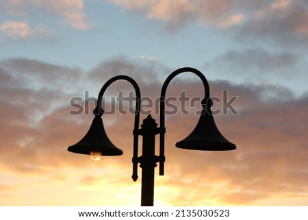 Street lamp backlit during sunset