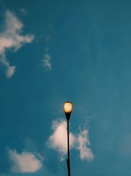 Street Lamp With Clouds Above It