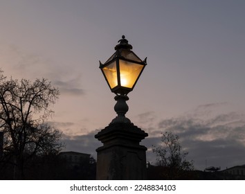 Street Lamp in the Glowing Sky: The Beauty of Light in the City at Dusk