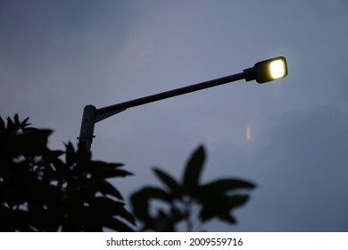 Street Lamp, Street Light In Neighborhood, With Dark Dawn Sky In The Background.